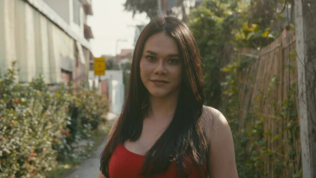 a beautiful trans woman looks at camera