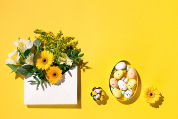 Yellow and white flowers, pastel easter eggs on paper yellow background. Spring, Easter card...