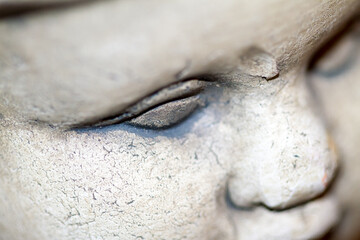 Obraz premium Close up detail of an old stone statue face