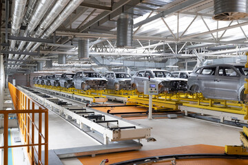 Car bodies are on assembly line. Factory for production of cars. Modern automotive industry