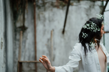 Beautiful asian girl with gypsophila flowers in her hairstyles dancing	