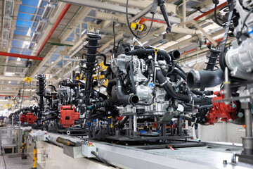 Photo of automobile production line. Welding car body. Modern car assembly plant. Auto industry. Interior of a high-tech factory, modern production