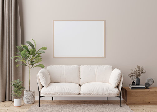 Empty horizontal picture frame on cream wall in modern living room. Mock up interior in scandinavian style. Free, copy space for your picture, poster. Sofa, table, dried grass, books. 3D rendering.