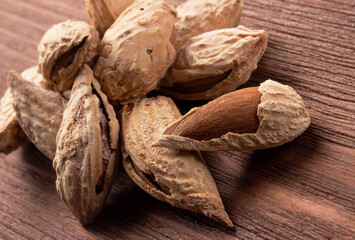 Salted almonds in a shell on a wooden background. Healthy proper nutrition, snack
