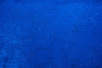Blue embossed abstract texture background. White blotches of fine dust on a blue background.