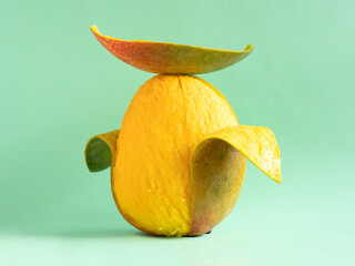 Portrait of a peeled mango wearing a mango peel hat.