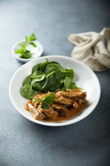 Homemade beef ragout with fresh spinach