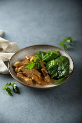 Homemade beef ragout with fresh spinach