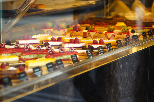 Tasty French pastry in a patisserie sweets shop from Paris. Quiches, croissants and other specific breakfast foods of France. photo inside.