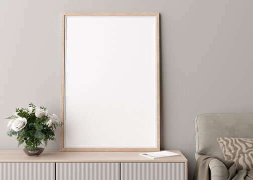 Empty vertical picture frame on cream wall in modern living room. Mock up interior in minimalist, scandinavian style. Free space for picture. Console, flowers in vase, armchair. 3D rendering.