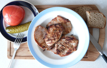 pork chops on a plate and vegetables