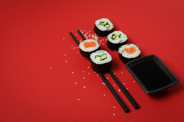 Concept of tasty food with maki on red background © Atlas