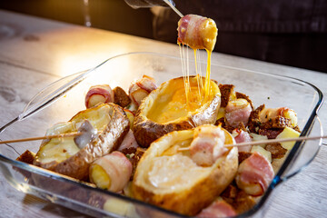 fondue of three types of cheese in potatoes with bacon