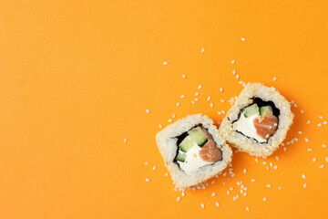 Concept of tasty food with rolls on orange background © Atlas
