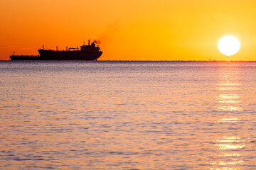 Fototapeta premium Tanker ship at sunset