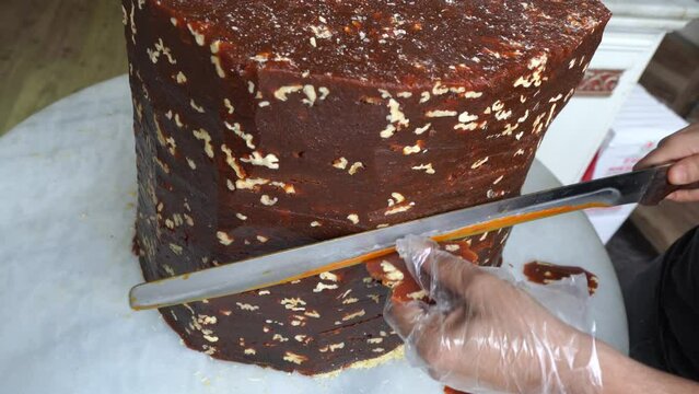 A candy maker slices cezerye, traditional Turkish candy made of carrot, sugar and coconat.  