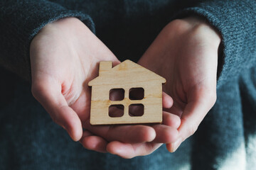 Hands of real estate agent offer house for rent or sale, affordable housing concepts, safe shelter and sweet home