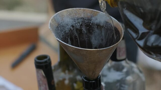 Molotov cocktail. War of Russia against Ukraine. Members of Kyiv territorial defense making mixture. Human hand twists the lace and prepares a molotov cocktail