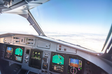 Interior view of the cockpit of a commercial airliner in flight. Pilots POV