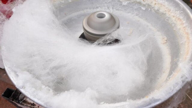 Making cotton candy or candy floss in festival, carnaval