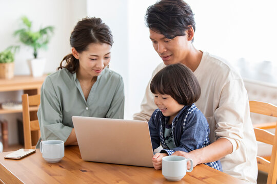 ノートパソコンを見る日本人家族