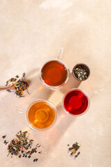 Tea of three types and colors in glass mugs with a double bottom