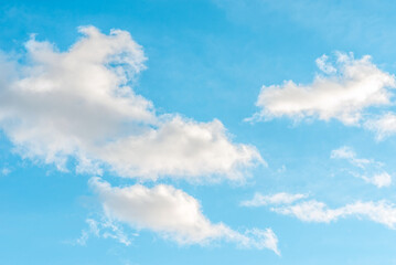 Naklejka na ściany i meble Nice cloudscape white fluffy clouds in the blue sky.Blue sky background with clouds