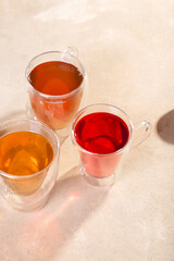 Tea of three types and colors in glass mugs with a double bottom