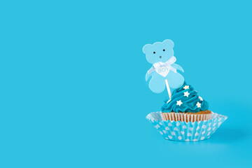 Blue cupcake for baby shower on blue background.Copy space