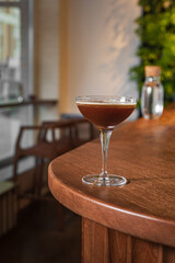Stylish tasty modern drink in a beautiful glass on the bar counter of the restaurant.