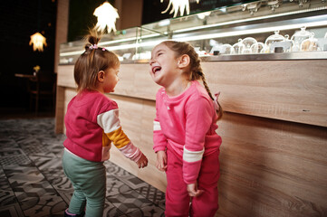 Two sisters in cafe having rest.