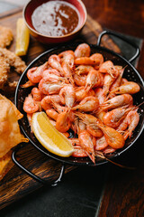 Seafood beer appetizers. shrimp, squid rings, lemon wedge, tomato sauce