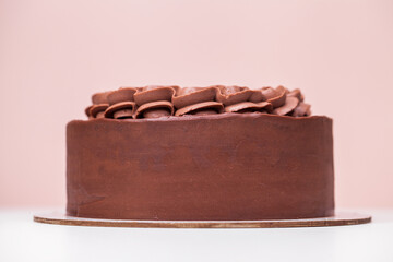 Homemade chocolate cake topped with whipped ganache
