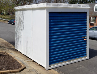 Temporary storage unit at curbside in residential neighborhood. - obrazy, fototapety, plakaty