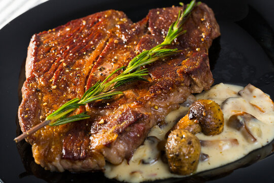 Beef entrecote with mushroom sauce is tasty dish in the kitchen.