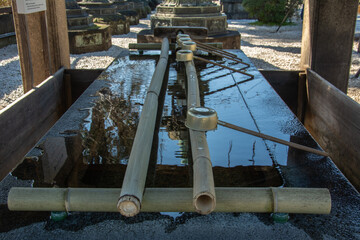 Chozu-ya or temizu-ya Shinto water ablution pavilion for a ceremonial purification rite known as temizu or chozu and large water-filled basin called a chozubachi in Tokyo, Japan