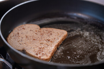 Making French toast. Toast frying in a pan.