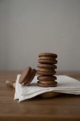 Sweet multicolored macaroons on a wooden background. Delicious multicolored macaroons. High-quality photography.