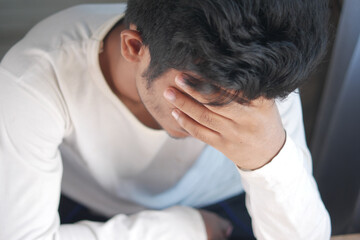 Fototapeta premium Young man suffering headache, close up 