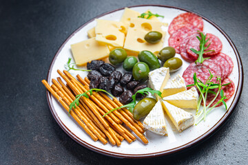 cheese plate snack sausage, olive, bread stick fresh appetizer meal food snack on the table copy space food background