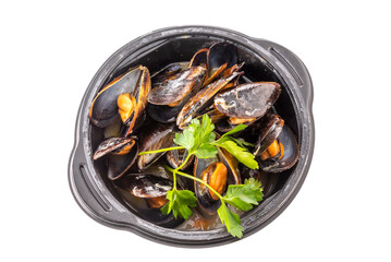 Mussels cooked with an Italian recipe called tarantina mussels in white, in a black plate with parsley isolated on white, top view, clipping path