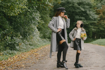 Cute and stylish family in a autumn park