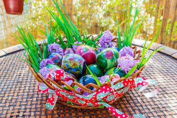 Fototapeta na wymiar Beautiful decorated wooden basket on sunny Easter day