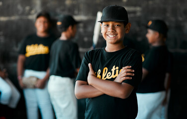 I started playing baseball because its fun. Portrait of a young baseball player standing with his arms crossed with his teammates standing in the background.