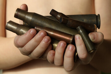 Stop war in Ukraine. shells and bullets in children arms