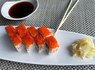 Rolls with salmon and cheese in a plate and soy sauce 