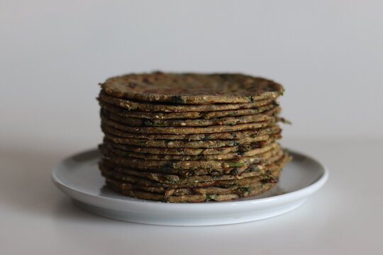 Bajra methi thepla. Indian flat bread made of pearl millet flour, fenugreek leaves, sesame seeds, yogurt and spices