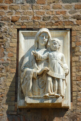 Fototapeta na wymiar Rome, Italy - June 2000: Stone relief of Mary, Mother of God