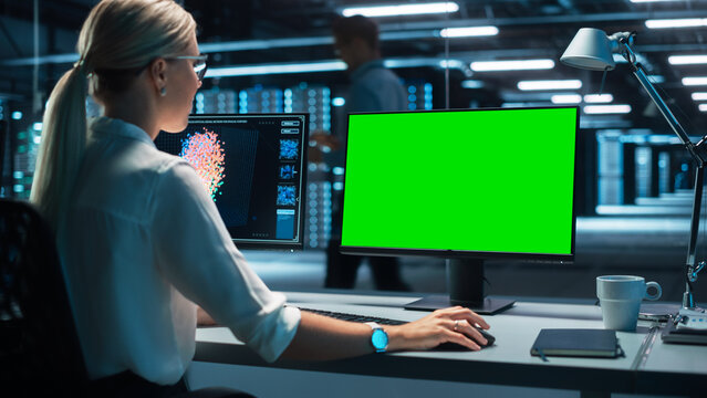 Female Information Technology Specialist and Data Center Administrator Working on her Computer, Monitoring Web Services, SAAS, Cloud Computing Facility, Performing Maintenance and Cyber Security