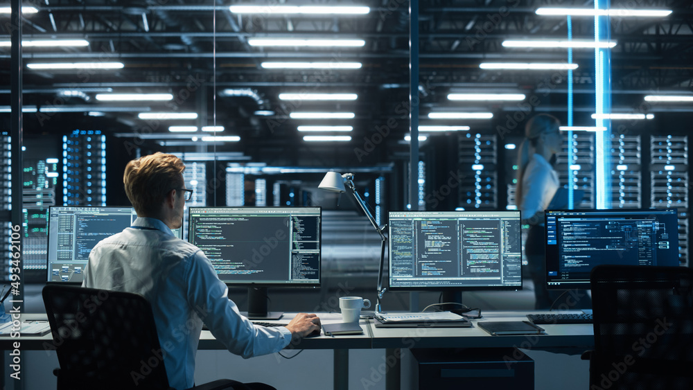 Poster System Administration and Machine Learning Engineer Programming at His Workstation. Man Plans and Carries Out Work to Expand the Network Structure of the Enterprise at His Office